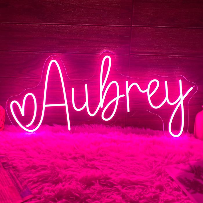 A pink neon sign displays the name 