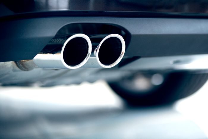 Stainless steel exhaust pipes on a blue car