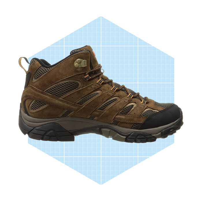 A brown hiking boot stands upright, showcasing its mesh and suede materials, set against a light blue grid background within a hexagonal outline.