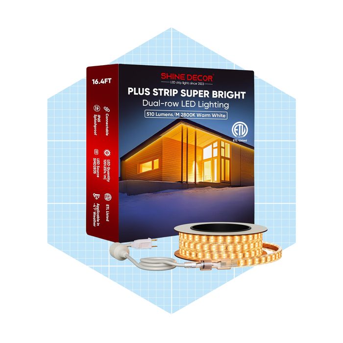A brightly packaged LED strip light displays its features, showcasing a roll of warm white LED lights alongside a power cord, set against a light blue background.