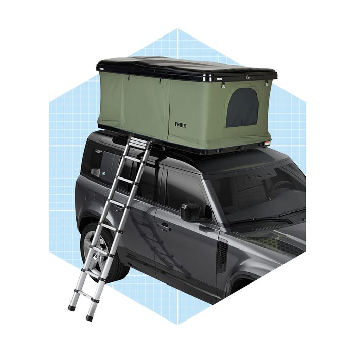 A rooftop tent sits atop a dark SUV, accessed by an extended aluminum ladder against a pale geometric background.