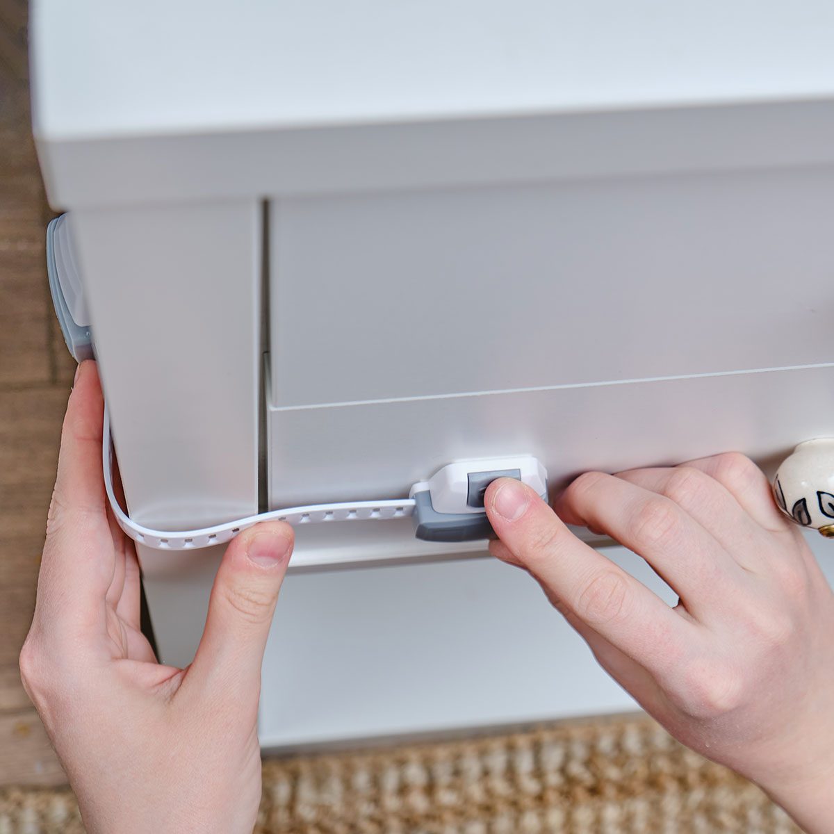 Child proof lock slides over cabinet door to keep children safe