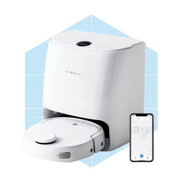 A robotic vacuum cleaner stands on a blue grid background. It appears ready to clean, with a mobile app displaying a map nearby.