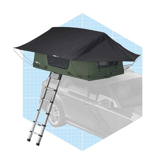 A rooftop tent is elevated above a car, with a ladder for access. It features a dark cover and green fabric, designed for camping.