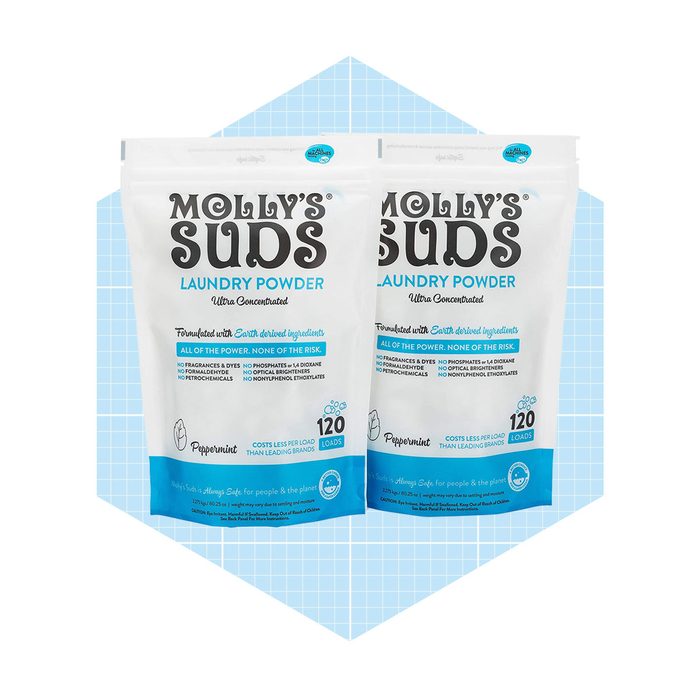 Two identical bags of Molly's Suds Laundry Powder are displayed together, prominently labeled, on a light blue grid background, indicating peppermint scent and 120 loads.