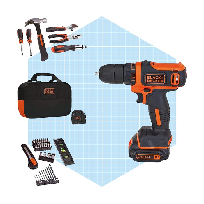 A cordless drill is displayed alongside various hand tools, a toolbox, and a measuring tape on a light blue grid background, suggesting a DIY context.