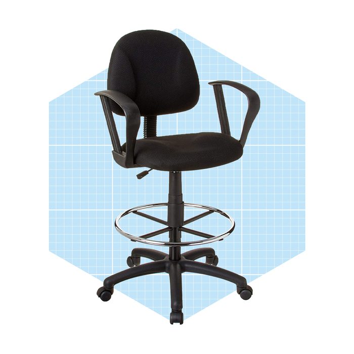 A black, ergonomic office chair with armrests and a footring stands on a wheeled base, set against a light blue grid-patterned background.