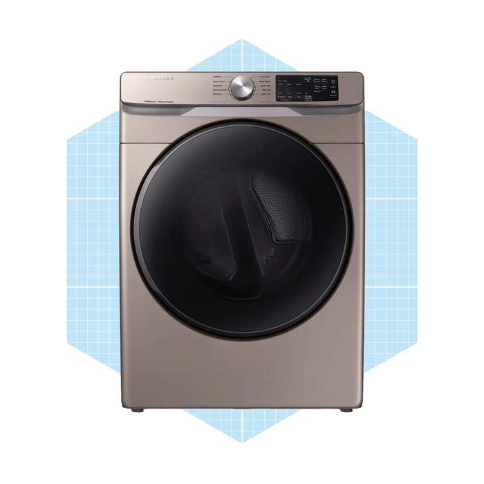 A metallic dryer stands upright, featuring a large circular door. It is set against a light blue geometric background. Controls are displayed on the top.