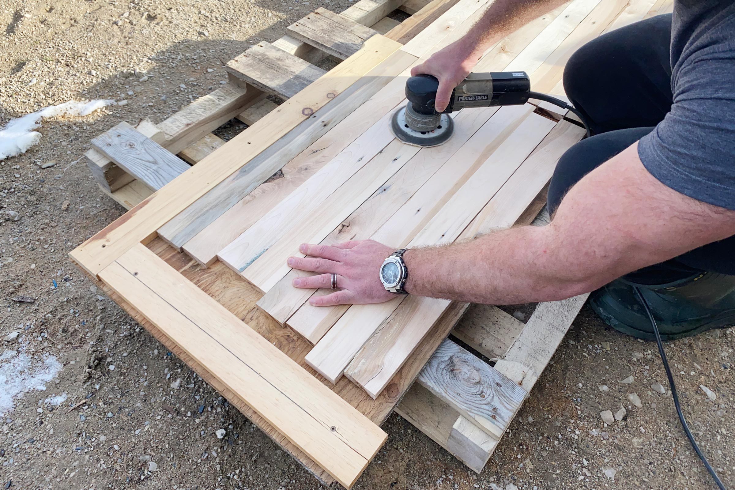  Sanding Tabletop Boards outside on the ground
