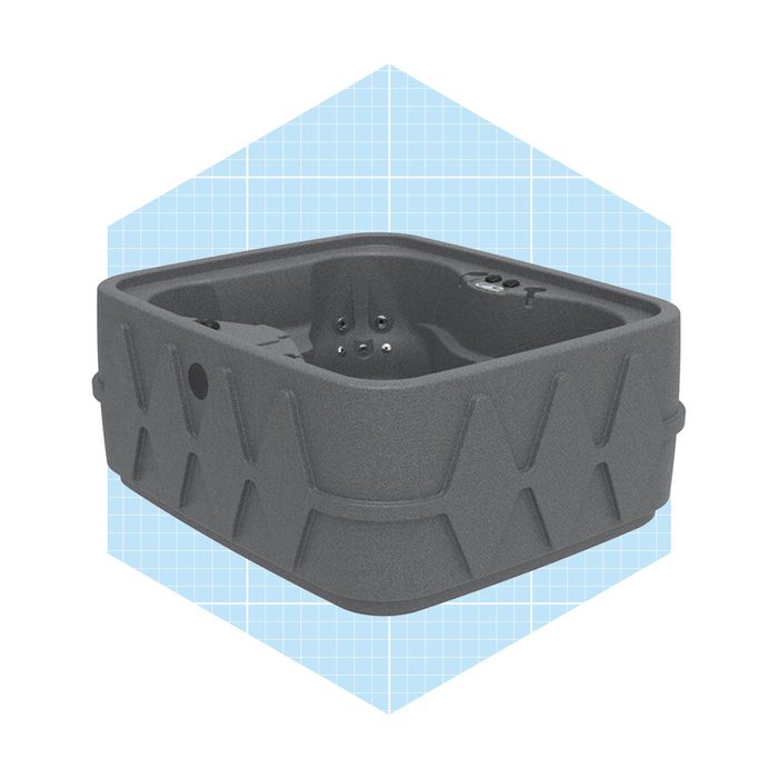 A rectangular, gray hot tub sits in a light blue, grid-patterned background, featuring air jets and a textured exterior for grip.