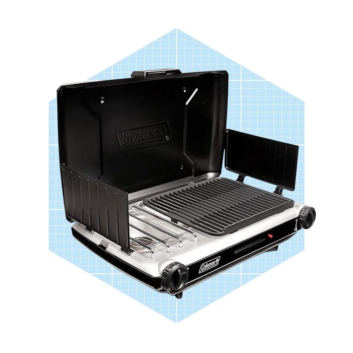 A portable gas grill features an open lid and side tables. It is set against a light blue grid background, ready for outdoor cooking.