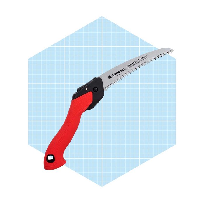 A red-handled pruning saw is positioned diagonally, showcasing its sharp, jagged blade against a light blue grid background.