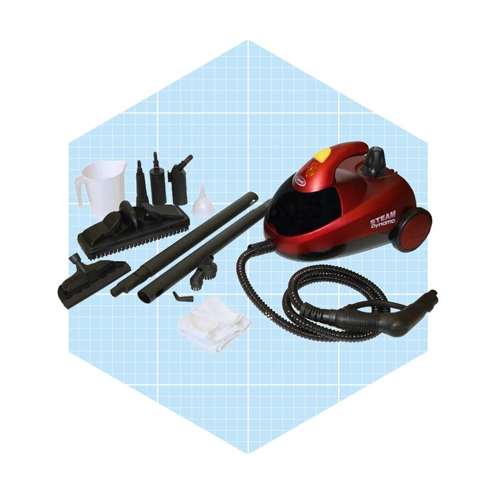 A red steam cleaner sits surrounded by various attachments and a measuring cup, arranged on a light blue grid background, ready for cleaning tasks.
