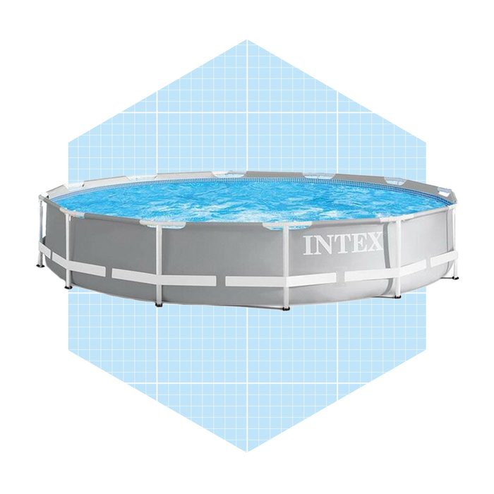 A circular above-ground pool holds clear water, surrounded by a white frame. It sits on a light blue grid background, suggesting a product display.