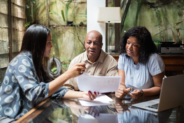 Real estate agent or finance advisor doing a meeting with customers at home