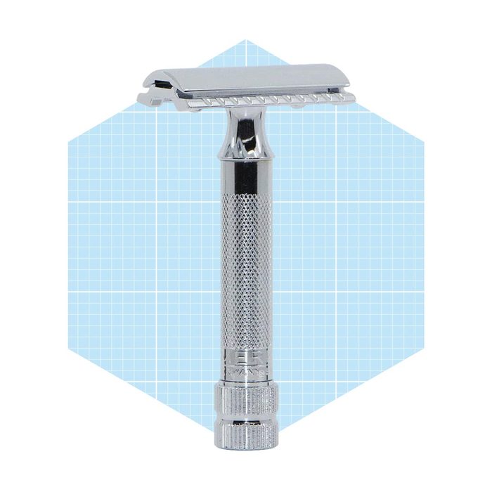 A chrome razor stands upright, showcasing its textured handle and blade head. It is set against a light blue geometric background.