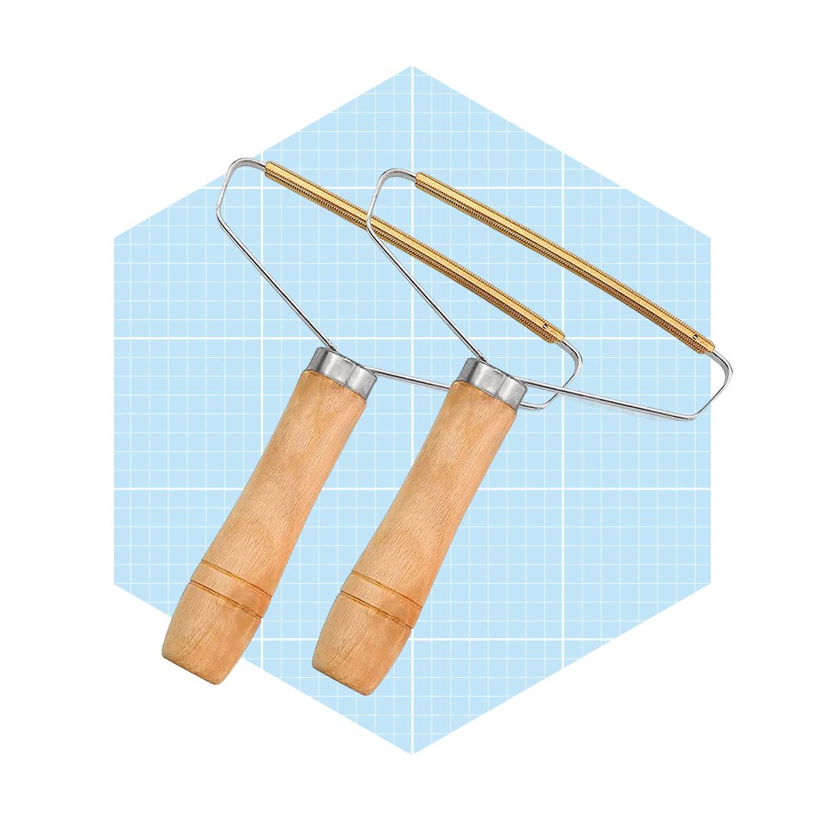 Two vegetable peelers with wooden handles are positioned against a light blue grid background. Their metal blades are ready for use in preparing food.