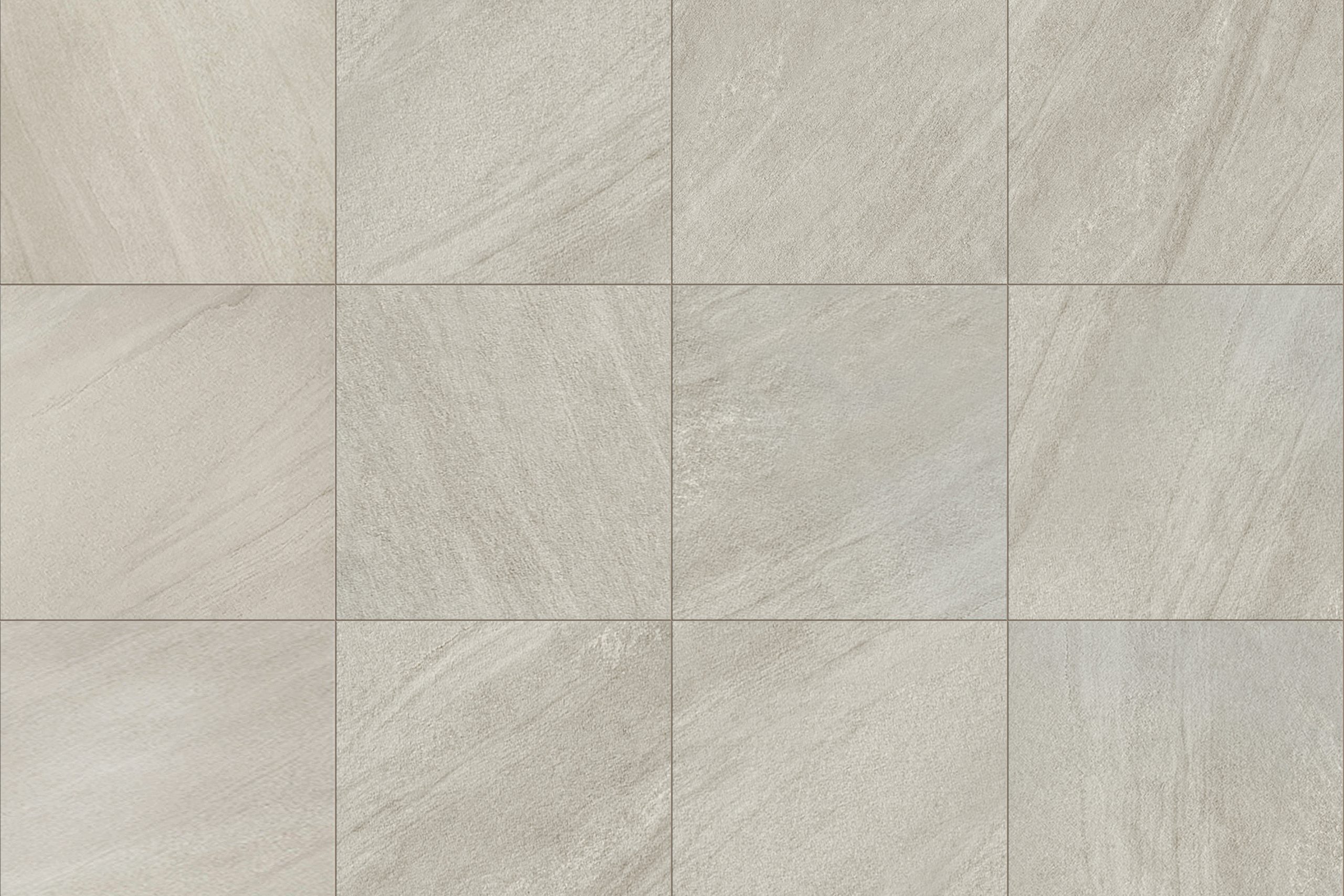 Gray tiles form a grid pattern on a flat surface, exhibiting subtle variations in texture and tone, suggesting a modern flooring option in a neutral palette.