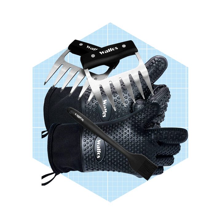 Black gardening gloves and tools, including a rake and brush, are arranged on a light blue grid background, emphasizing their purpose for landscape maintenance.