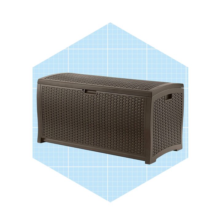 A rectangular storage box with a woven texture holds items inside, placed against a light blue grid background.