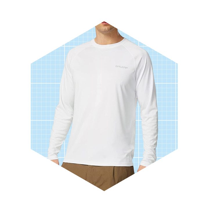 A person wears a white long-sleeve shirt, standing against a light blue grid background, suggesting a casual or athletic context.
