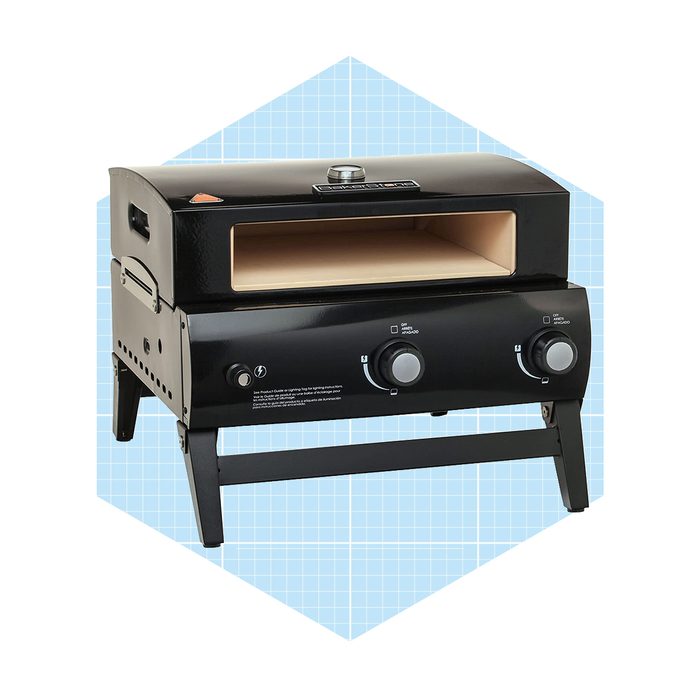A black outdoor pizza oven sits on a sturdy frame, featuring a large opening and temperature controls for cooking pizzas. Background is a light blue grid.