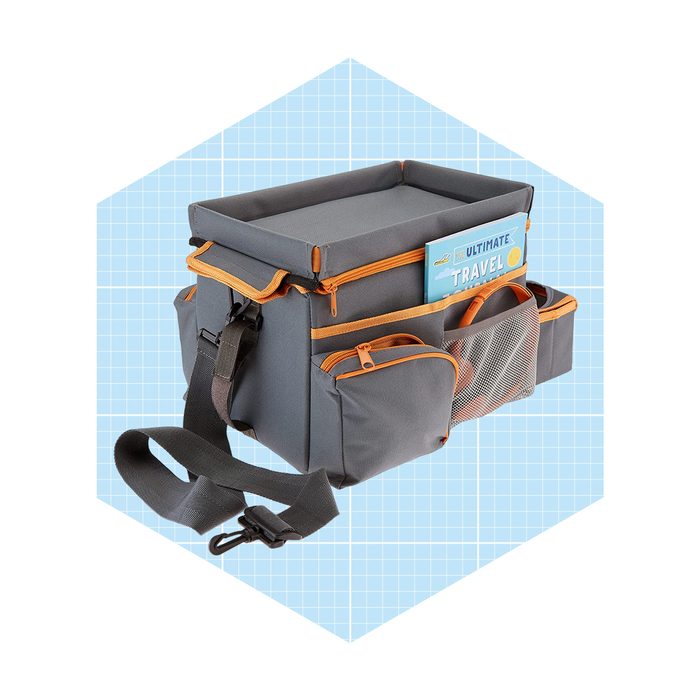 A gray travel bag with orange accents sits against a light blue grid background, showcasing multiple pockets and a top compartment.