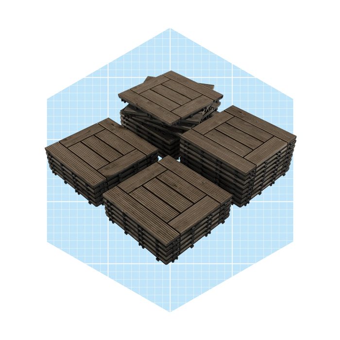 Stacks of wooden pallets are arranged in a pile, showing their textured surfaces, set against a light blue grid background.