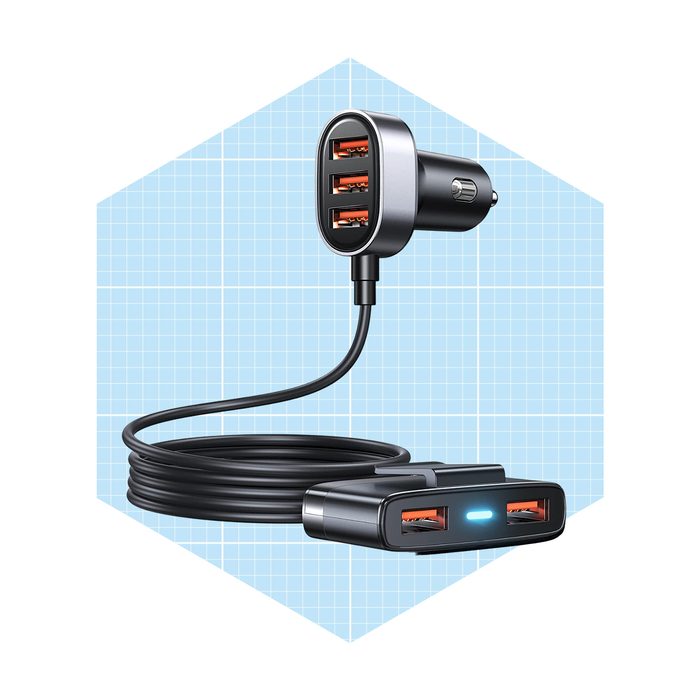 A car charger with three USB ports connects to a vehicle's socket via a long cable, designed to charge multiple devices simultaneously in a vehicle.