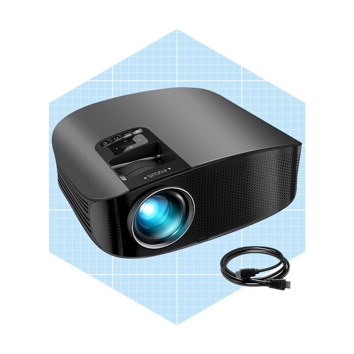 A projector emits a blue light from its lens, while a connecting cable rests beside it, set against a light blue grid background.