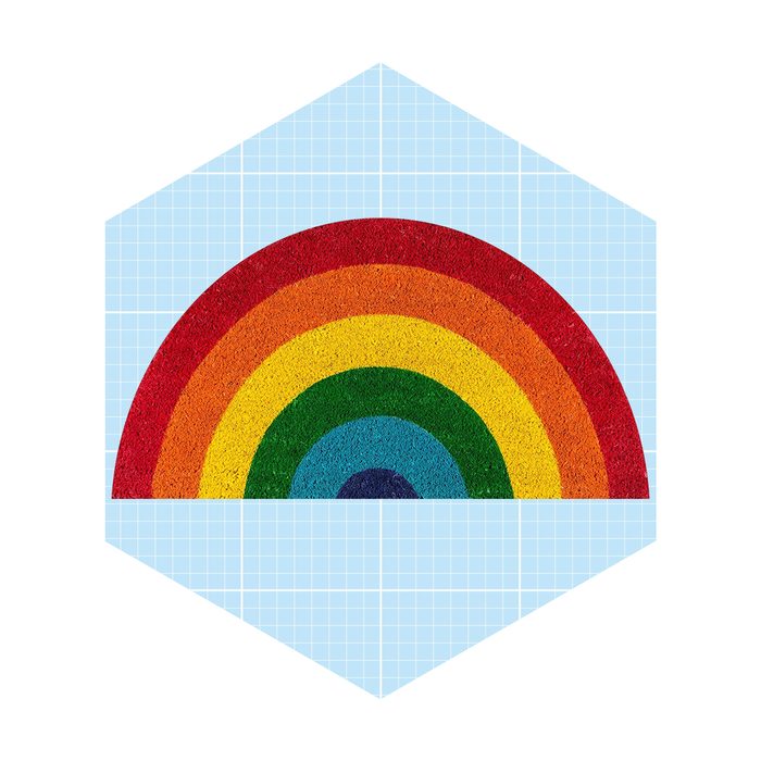 A colorful rainbow arches above a blue grid background, partially visible within a hexagonal shape, suggesting a vibrant, artistic design.