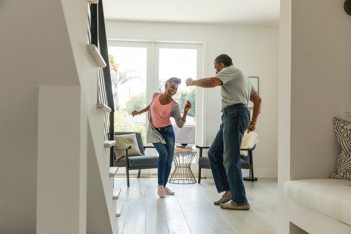 Mature couple dancing in living room