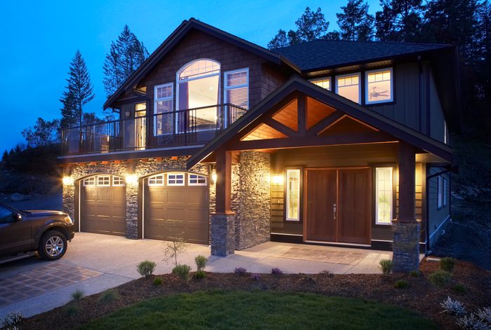 Modern house with car parked on drive, dusk