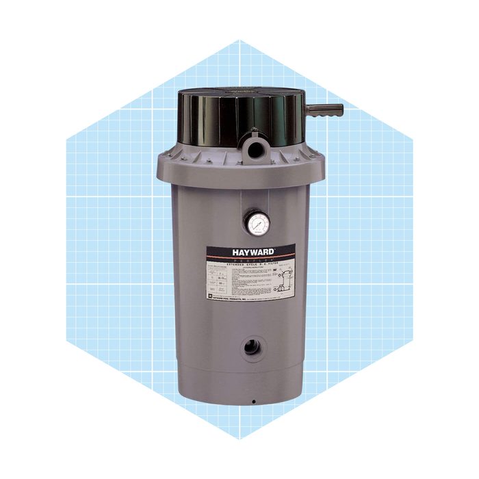 A gray pool filter stands upright, featuring a black top and a pressure gauge. It is set against a light blue grid background.