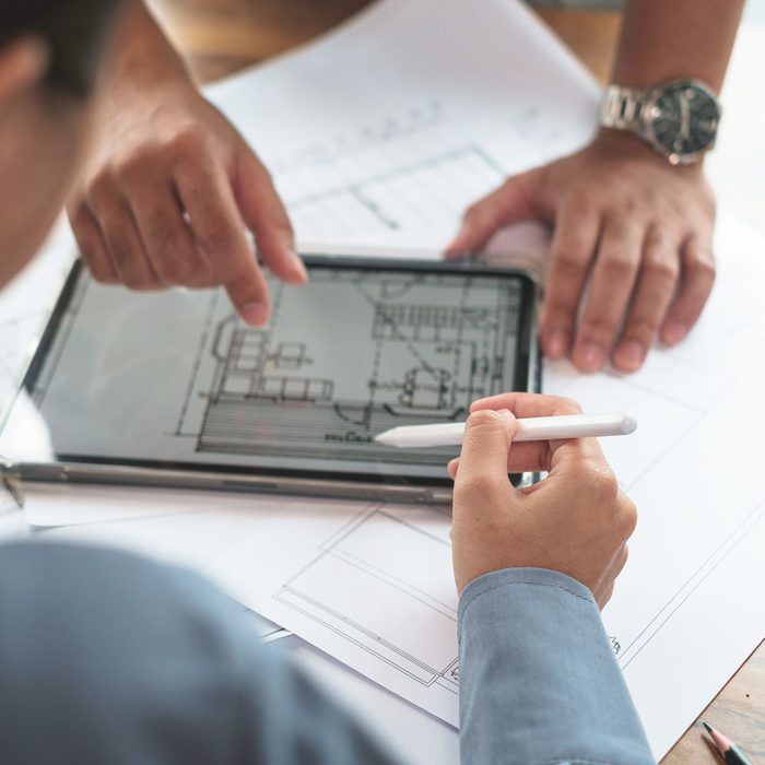 Architect Or Engineer Team Designer Discussing Detail Drawing On Digital Tablet.