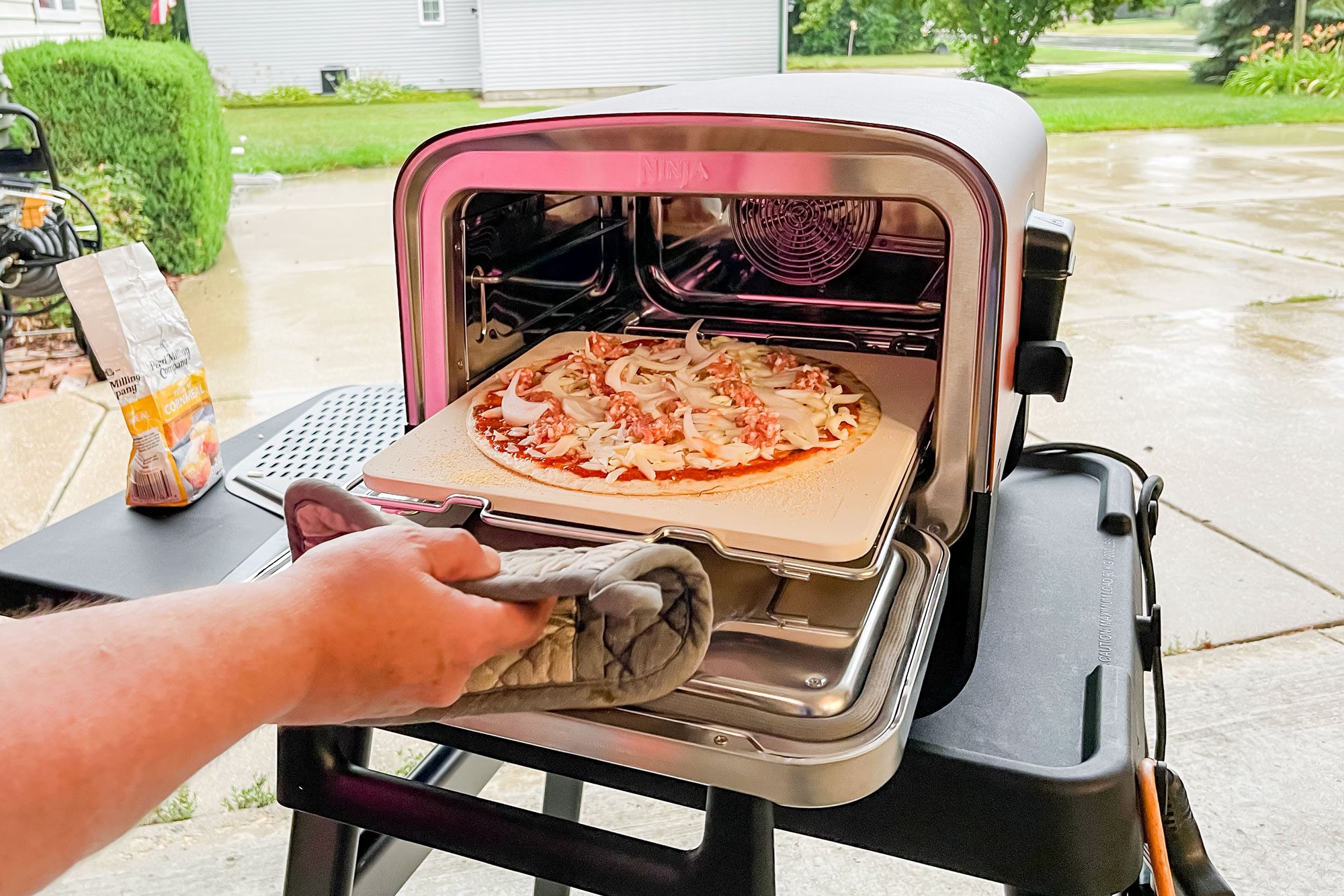 Putting Pizza into Ninja Woodfire Outdoor Oven