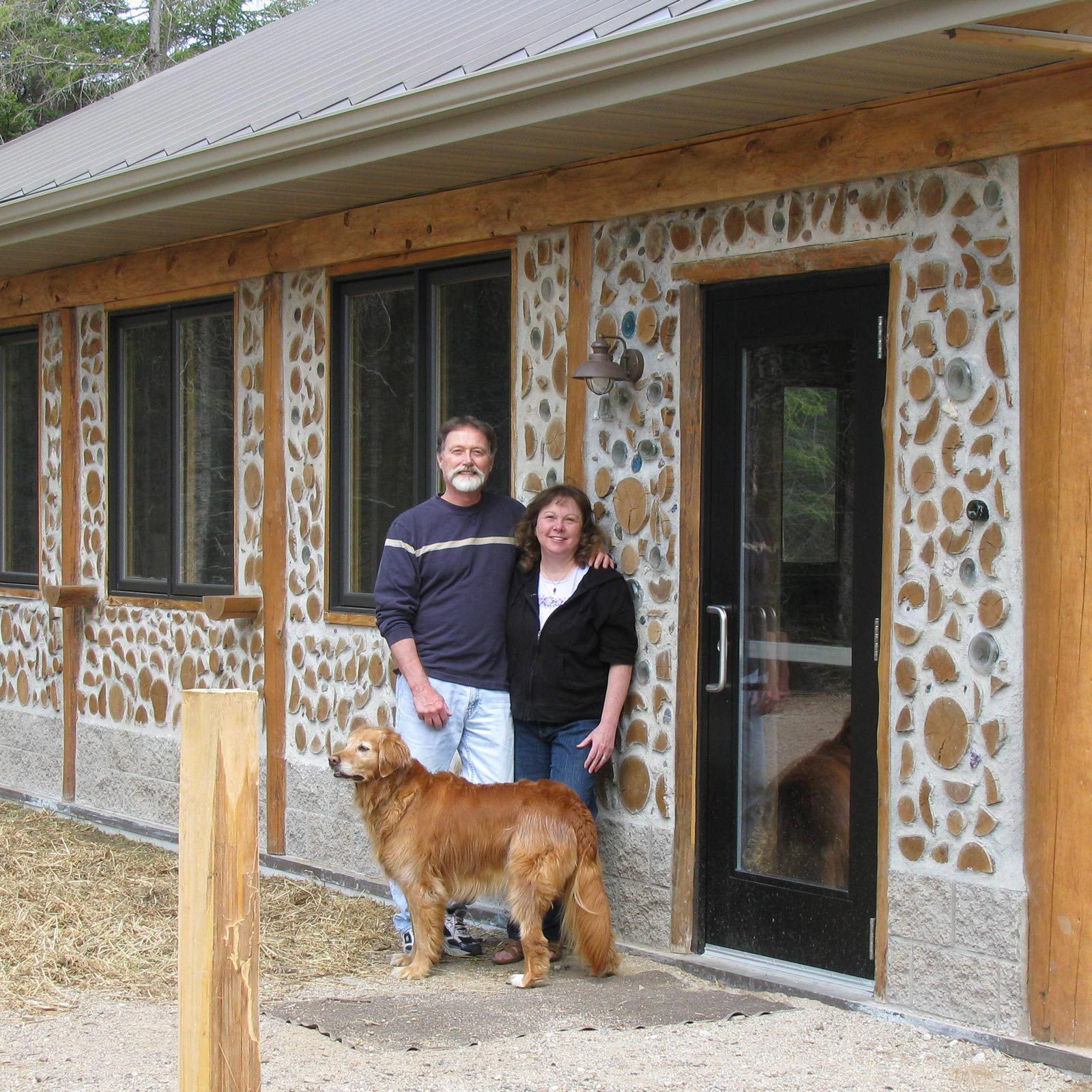 Rich, Becky and their dog at the Cordwood Classroom