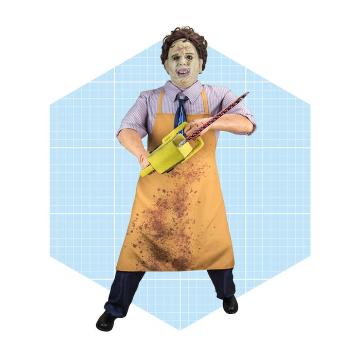A person with a mask holds a chainsaw, wearing a dirty apron. They stand against a light blue grid background, suggesting a playful yet unsettling theme.