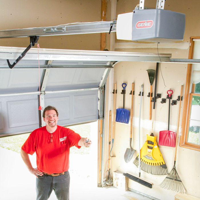 A Man Operating Garage Door Opener with Remote, How To Install A Replacement Garage Door Opener Fh10sep 511 54 049 Ksedit