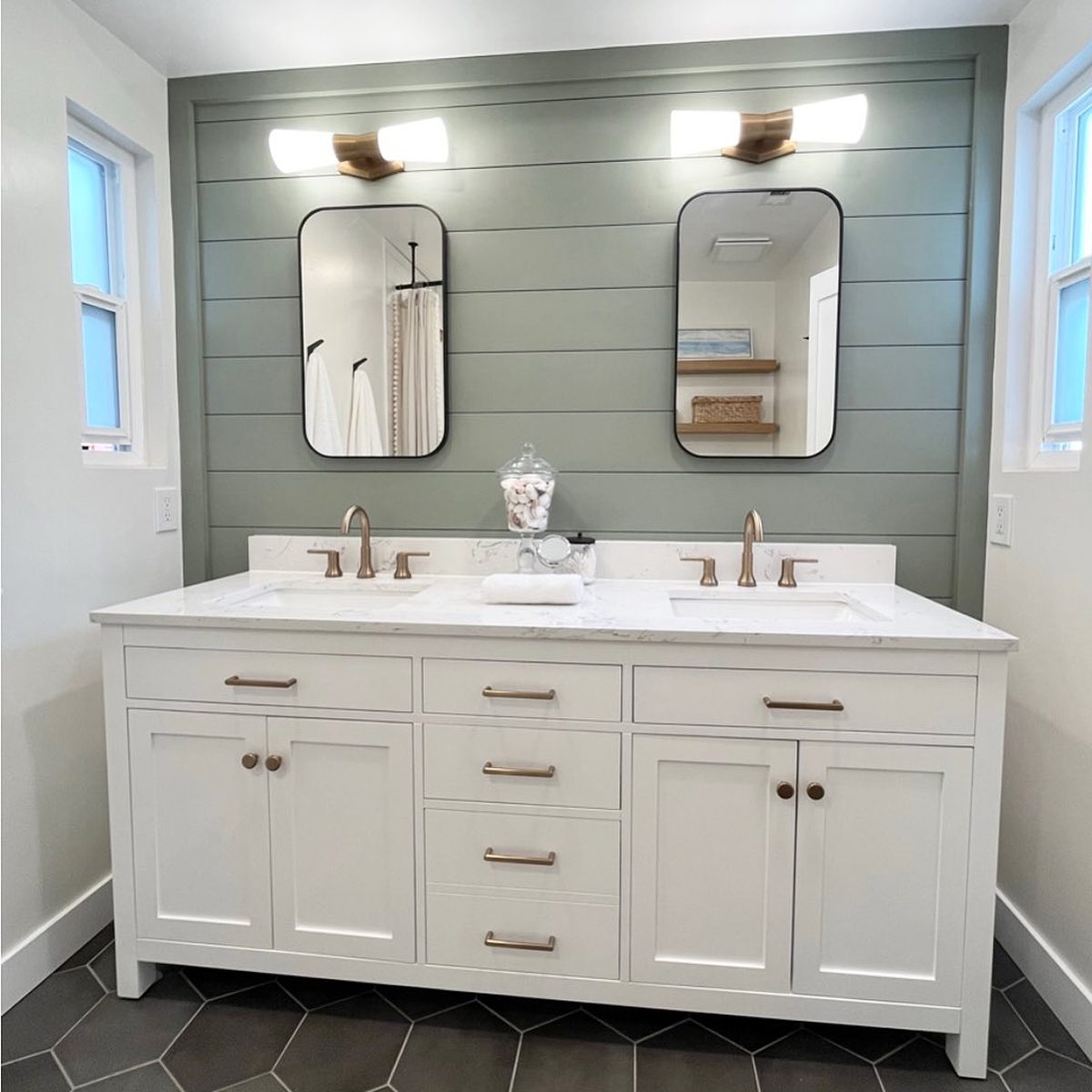 Two mirrors on a grey wall inside bathroom