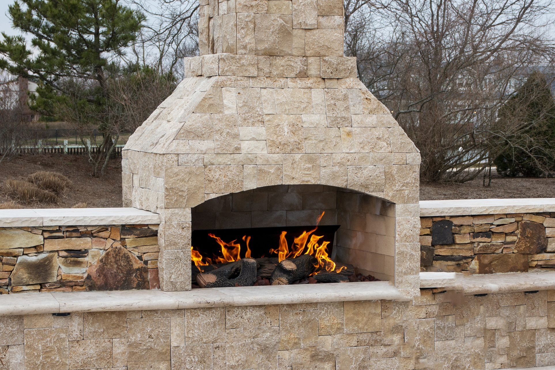 Paving stone fireplace burning on deck