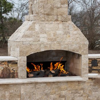 Paving stone fireplace burning on deck