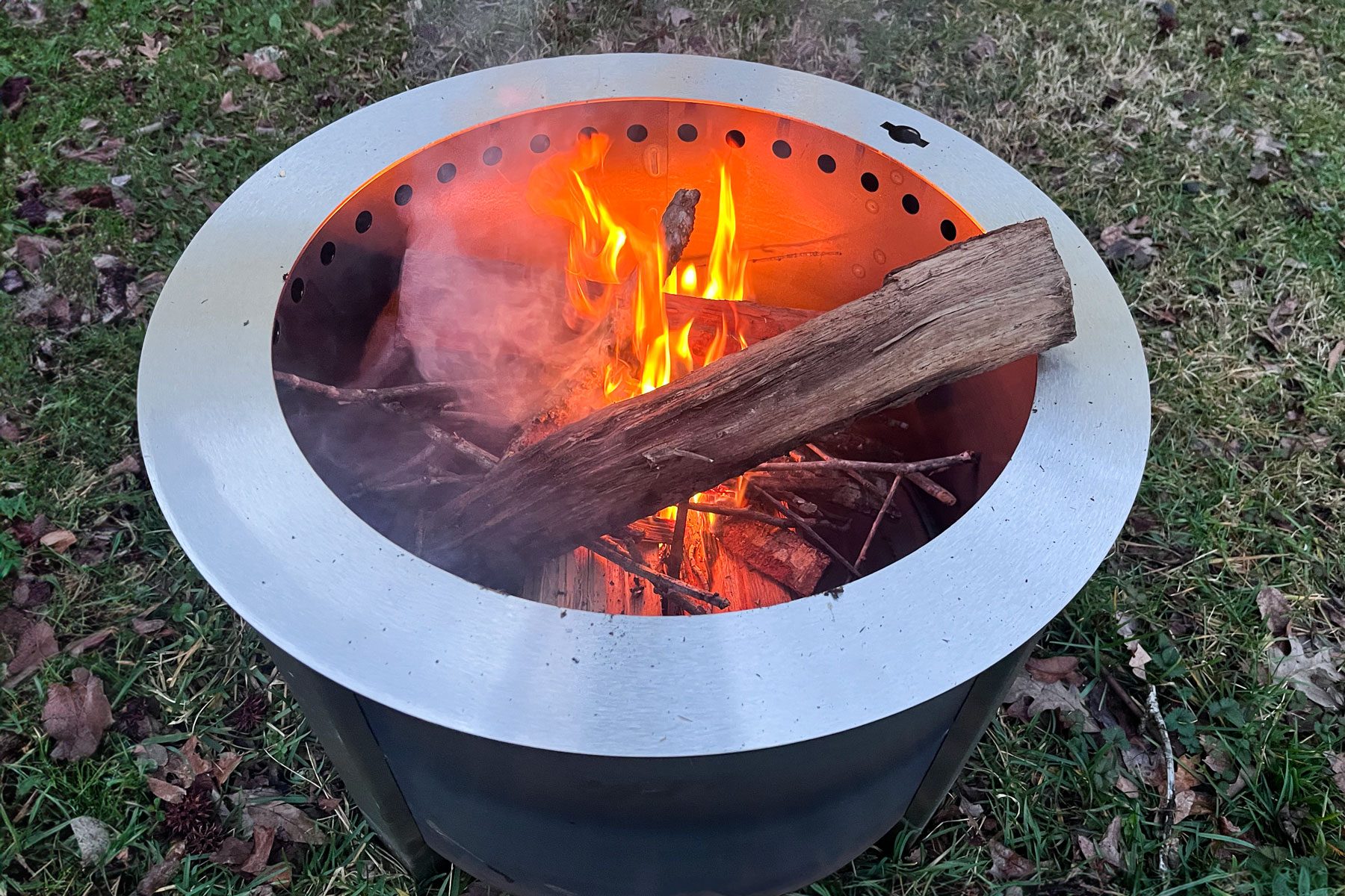 Burning wood in side the breeo stove in the backyard