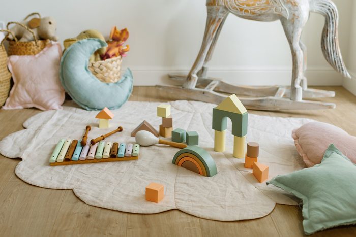 children's toys on linen rug with baskets in the background