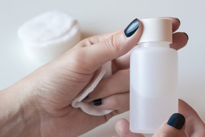 Woman is holding a nail polish remover